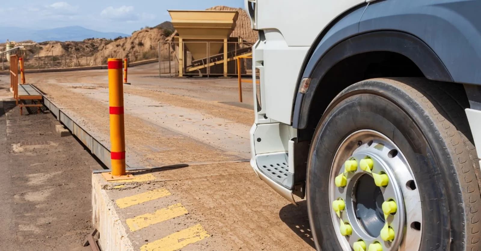 Truck entering a weighing scale in a quarry.